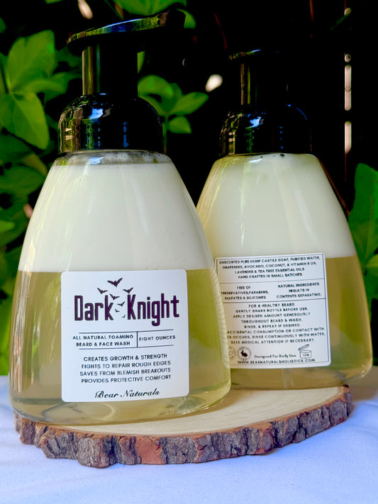 Two 8 ounce bottles of 'Dark Knight' all natural beard wash product on a wooden block with a natural background