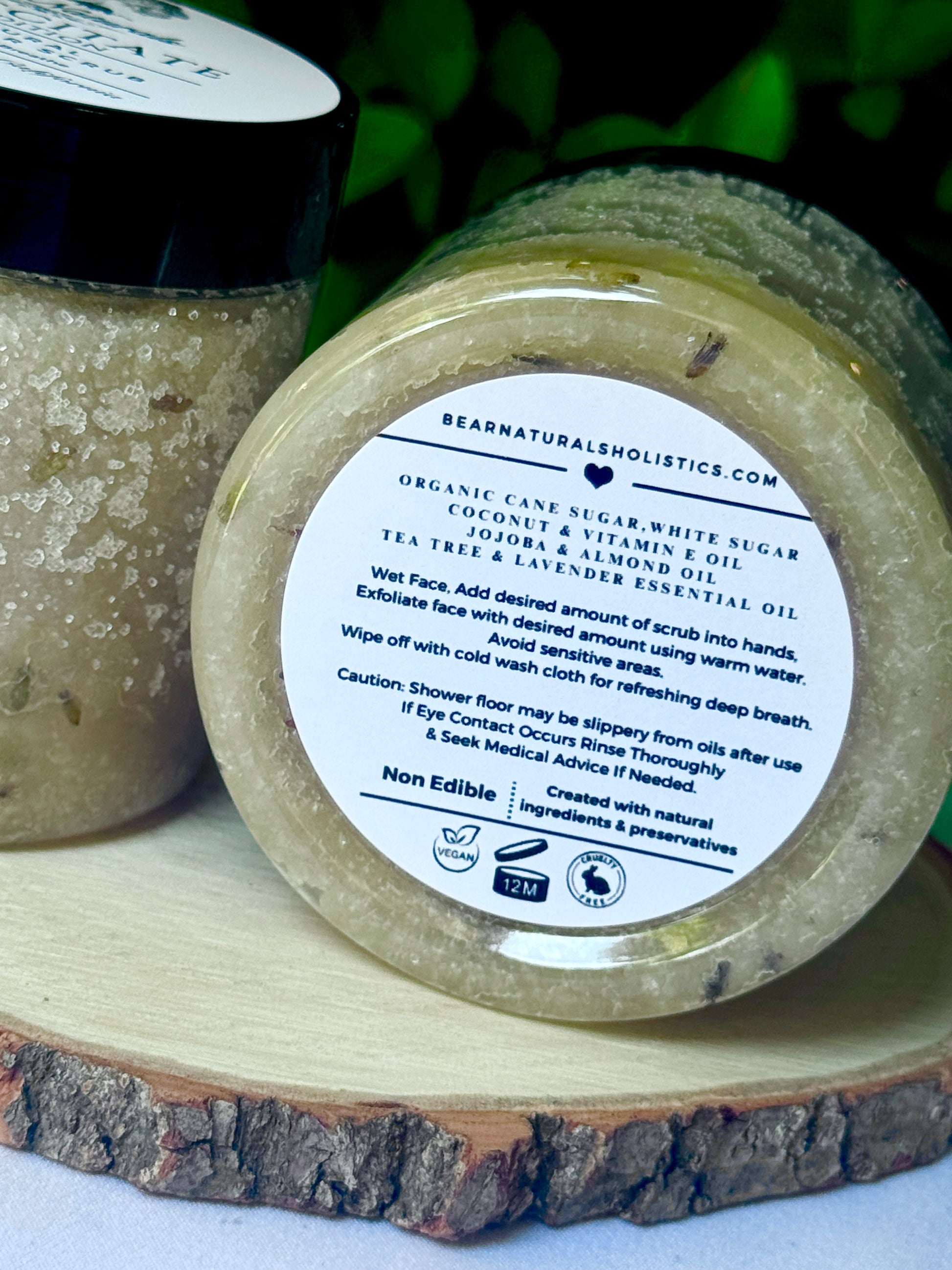 Jar of organic face scrub with a label on a wooden surface